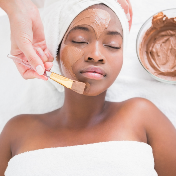 Black woman getting a facial.