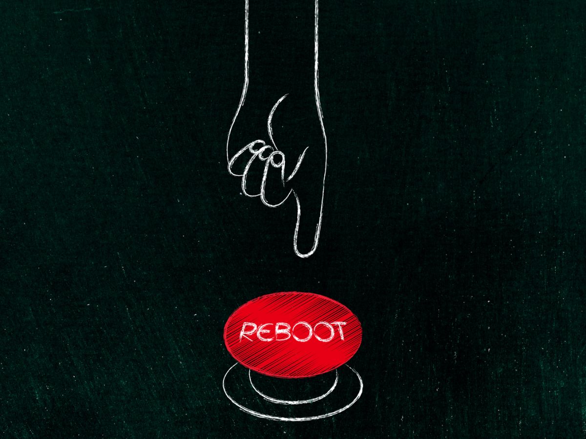 Image with a finger pointing to a button with the word "reboot" on it