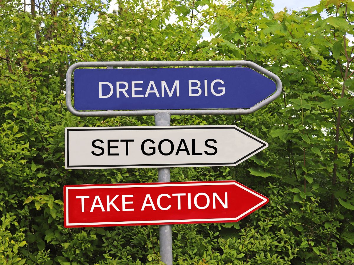 A sign with words: Dream Big, Set Goals, and Take Action